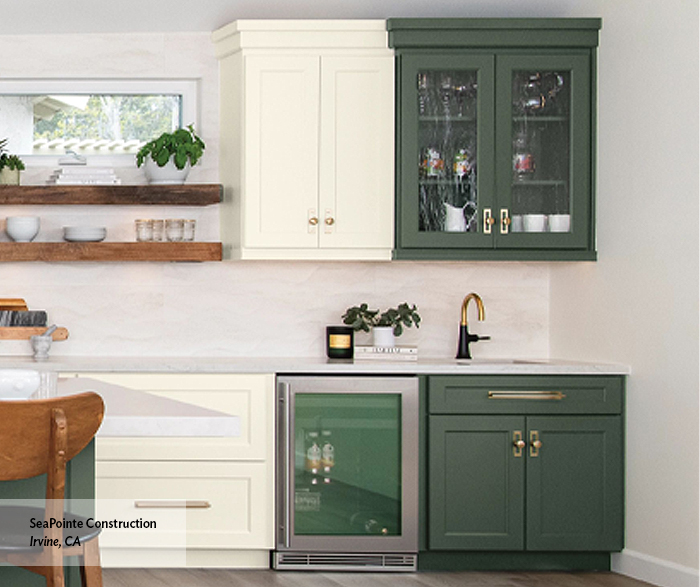modern kitchen with light white and green wood cabinetry and sleek countertops